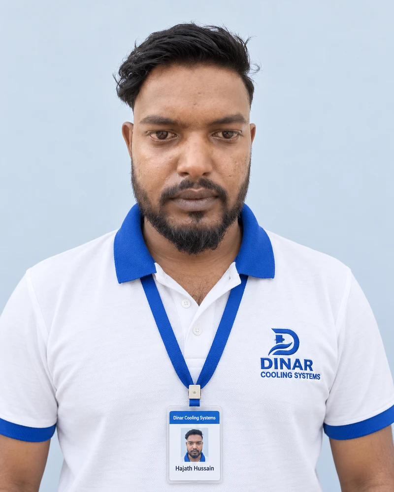 Hajath Hussain wearing a Dinar Cooling Systems polo shirt and ID card