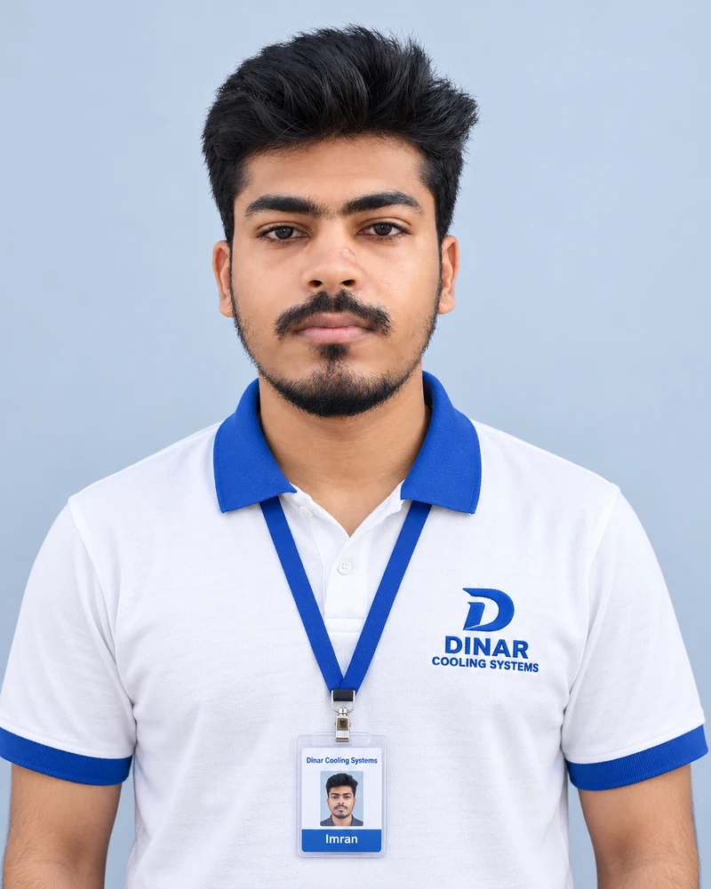 Imran wearing a Dinar Cooling Systems polo shirt and ID card
