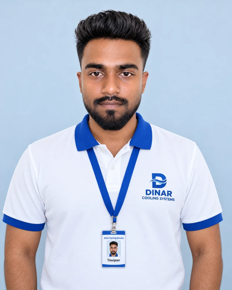 Touqeer wearing a Dinar Cooling Systems polo shirt and ID card